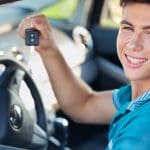 Man Holding Car Keys In Driver's Seat.