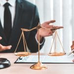 Scale Of Justice And Gravel On Lawyers Desk
